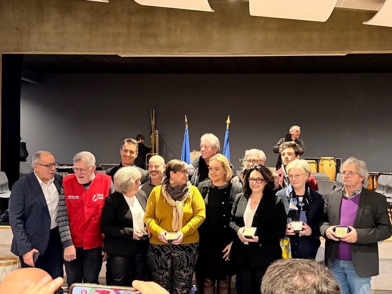Group of award recipients gathered during the French National Assembly medal award ceremony, alongside a Member of Parliament